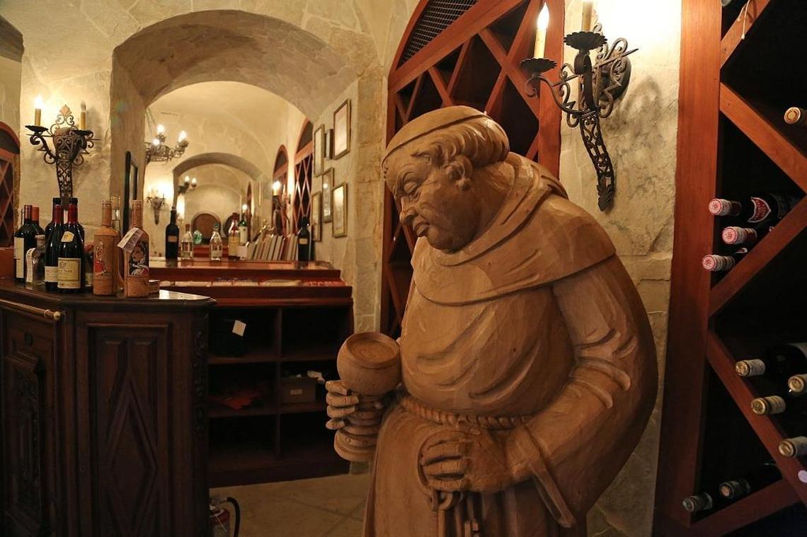This statue of a monk and other contents of Thomas Kramer’s wine cellar are included in the sale.