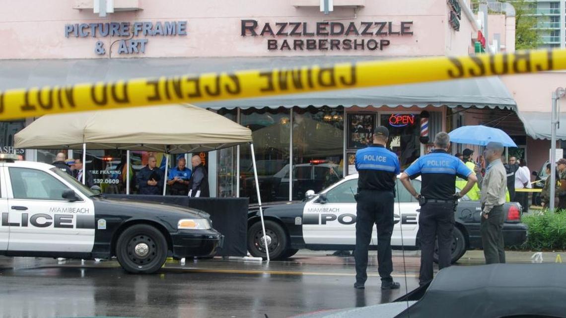 Miami Beach police survey the scene where alleged bank robber David Winesett was shot and killed by police near Alton Road and 16th street in Miami Beach.