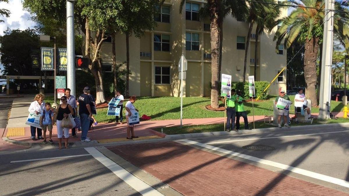 At Rebecca Towers in Miami Beach, campaigners are campaigning and voters are trickling in to cast their ballots.
