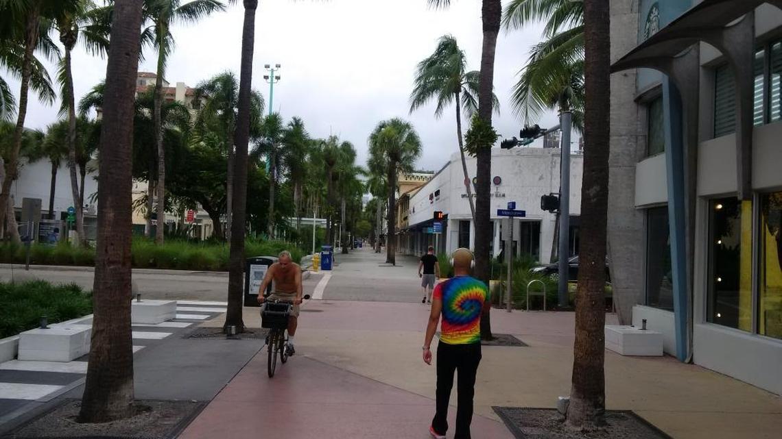 Early morning walkers along Lincoln Road, which will soon get concrete barriers at Alton Road and Washington Avenue.