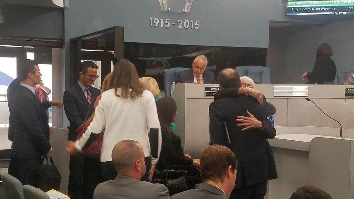 Supporters of the Sabrina Cohen Foundation embrace after the Miami Beach commission approves plans for a facility that will provide beach access for people with disabilities on Tuesday, Oct. 31, 2017.