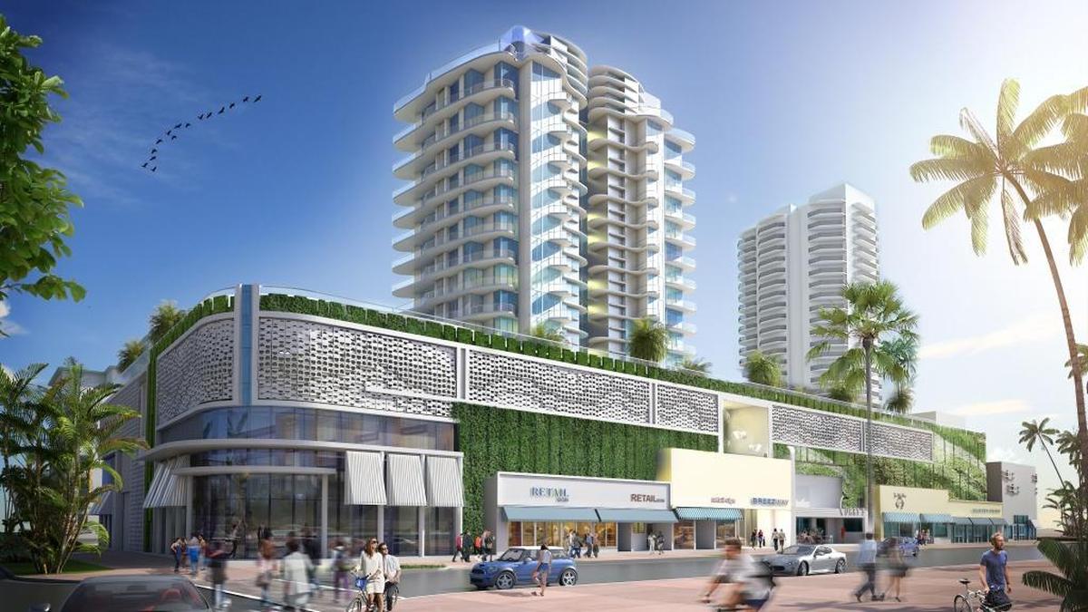 This rendering shows the view from the corner of 75th Street and Collins Avenue facing east. The corner building would be completely replaced with a rounded storefront while the rest of the facades along Collins would be faithfully restored with historic features. Above the storefronts, a landscaped wall would be topped with textured masonry to mask the parking garage for the development.