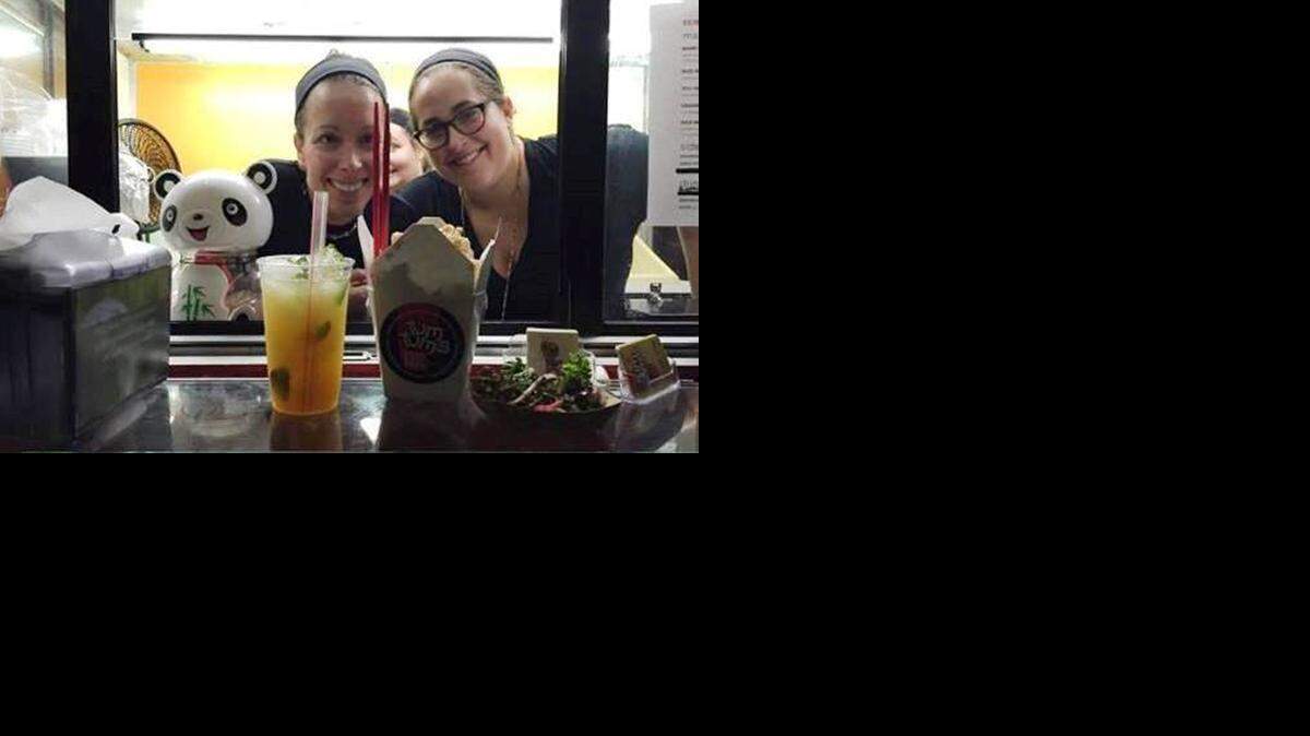 
Chef Jacquelyn Packar (right), shows off some of Tum Tum's offerings with partner Jill Schenker.
