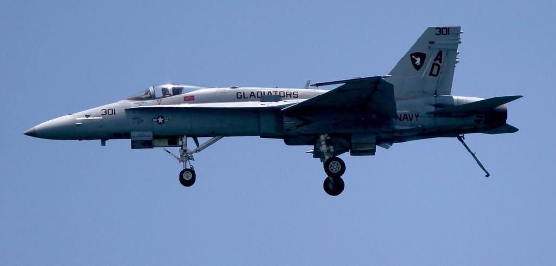 A U.S. Navy F-18 Hornet displays its landing gear during the air and sea show in Miami Beach on Sunday.