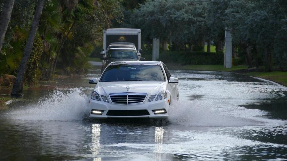 Cars wade through the king tide water on North Bay Road in 2015.