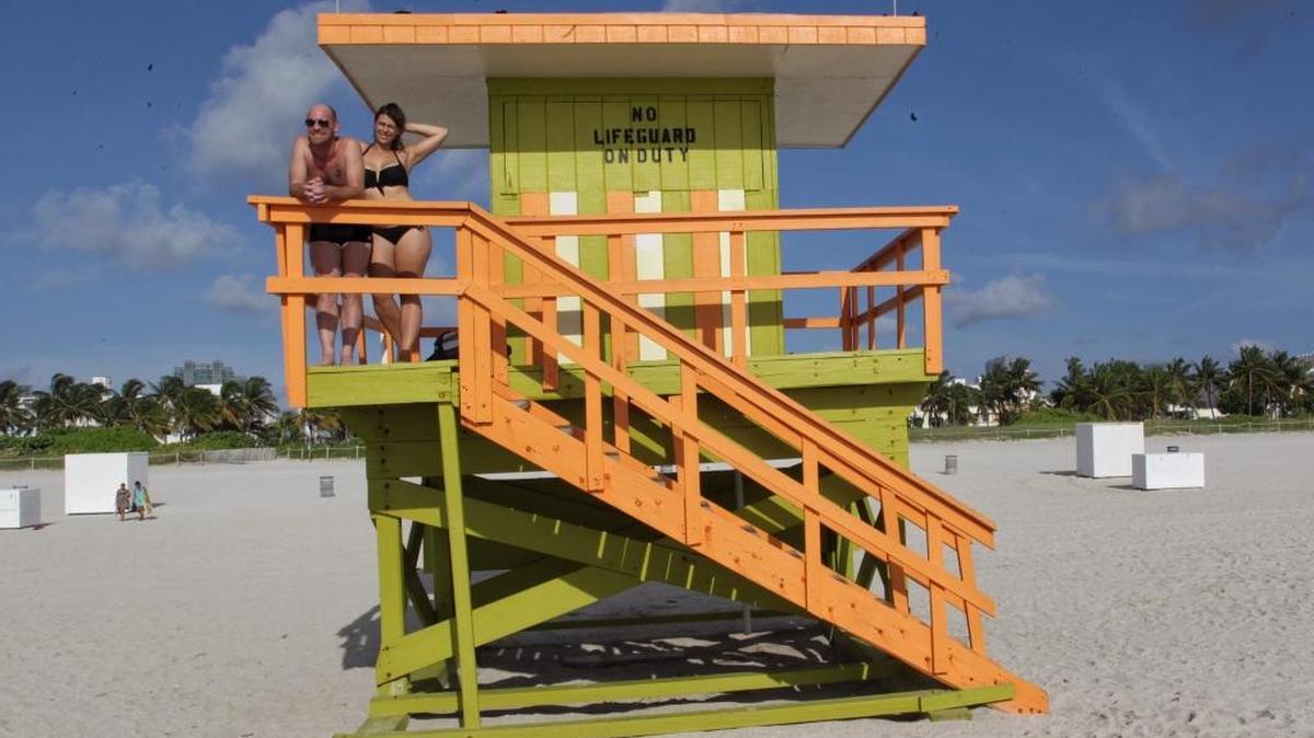 
Tourists Herzig Gregory, 36, left, and Uli Boehnisch, 29, right, take in the blue skies and sunny weather Monday morning as they spend their last day in Miami Beach before heading home after several days of rain and the threat of Tropical Storm Erika.
