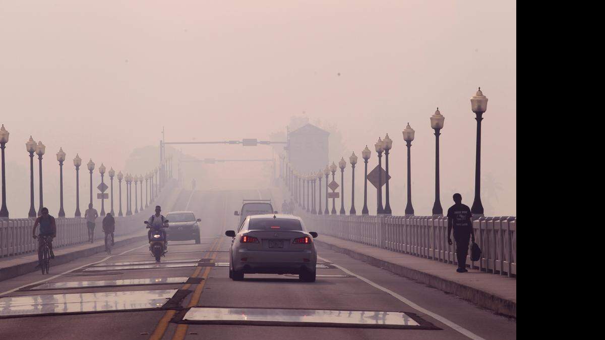 
Commuters make their way across the Venetian Causeway, which has portions of weak concrete patched by metal plates.
