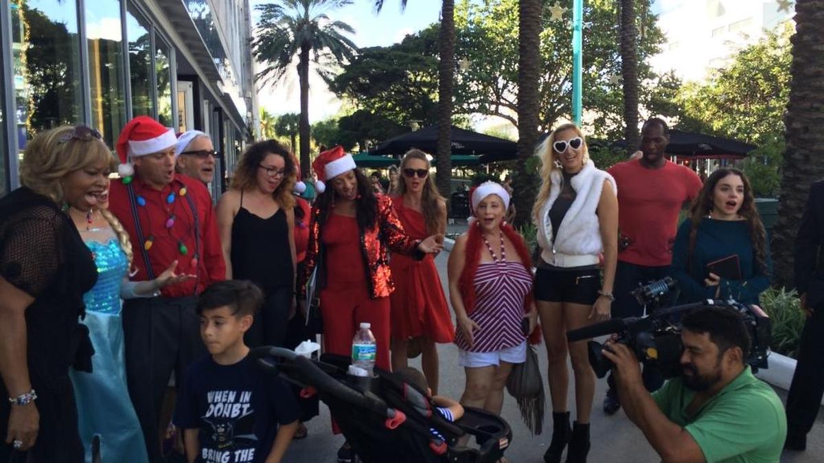Dress rehearsal for Dec. 20 Christmas caroling event, with “Deco Drive” on the scene
