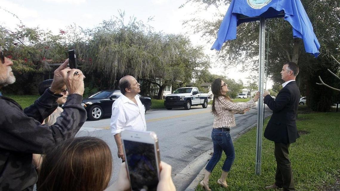 Town of Surfside Mayor Daniel Dietch, right, and Jackie Tepper unveil a street sign designating 89th Street at Irving Avenue as Sid Tepper Street on Friday, Dec. 16, 2016. Tepper composed the hit song ‘Red Roses For a Blue Lady,’ along with other popular tunes.