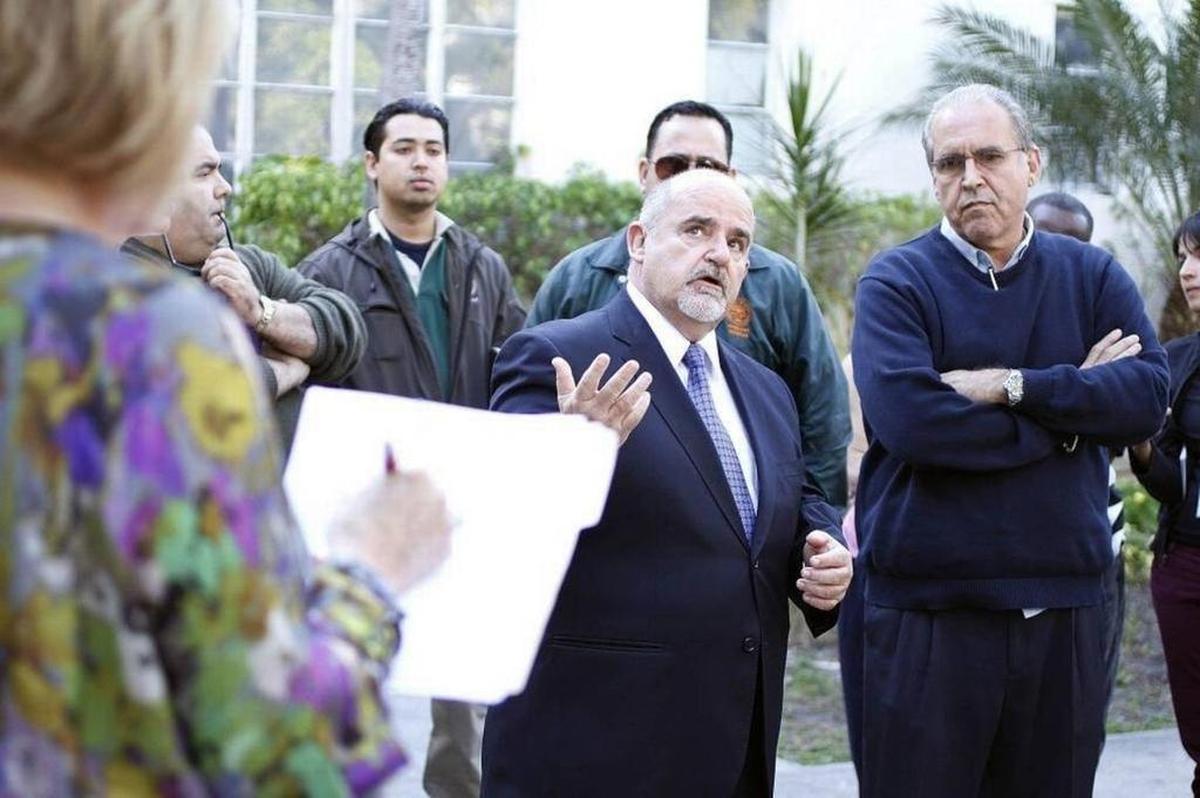 Mariano Fernandez, center, surrendered to the Miami-Dade state attorney’s office on a charge of receiving unlawful compensation while serving as Miami Beach’s building official.