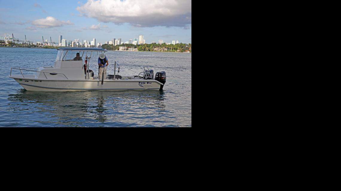 
Jeff Absten, left, research faculty at FIU, and Jim Duquesnel, marine biologist, gather water samples during the "king tide" on Miami Beach’s bay side on Thursday, Oct. 9, 2014. 
