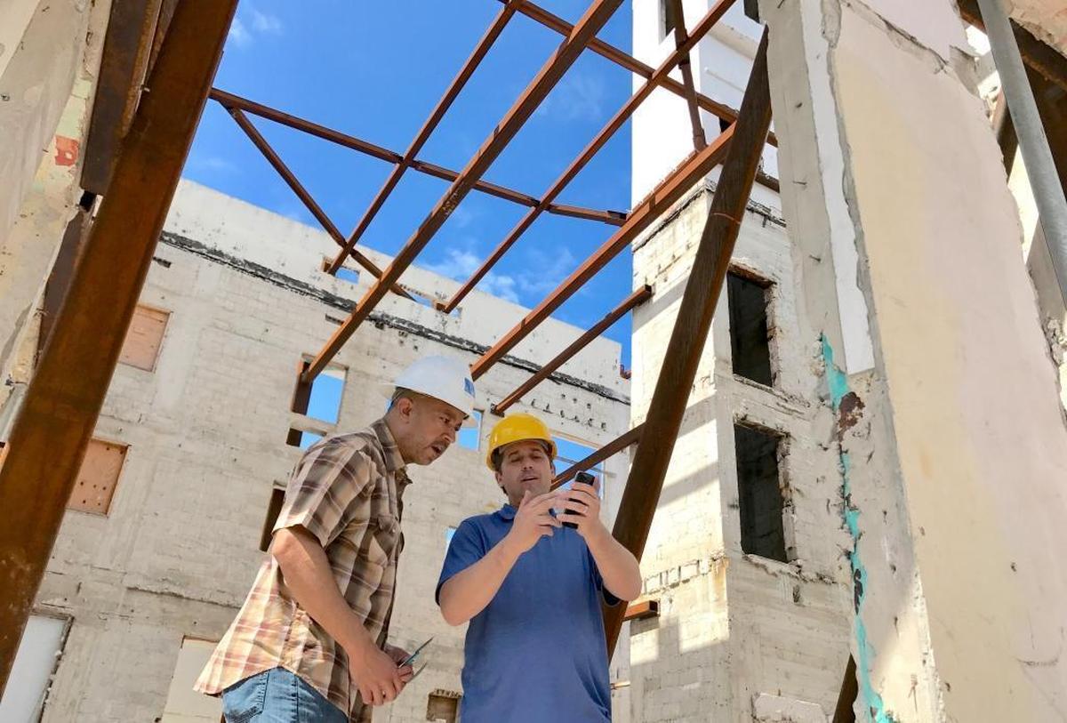 Building engineer Edward Fields, left, talks with Jason Devooght, a a building elevation contractor based out of New Jersey. Fields is project manager for the restoration of the historic Greystone Hotel in South Beach, where he met contractors to talk about lifting historic structures.