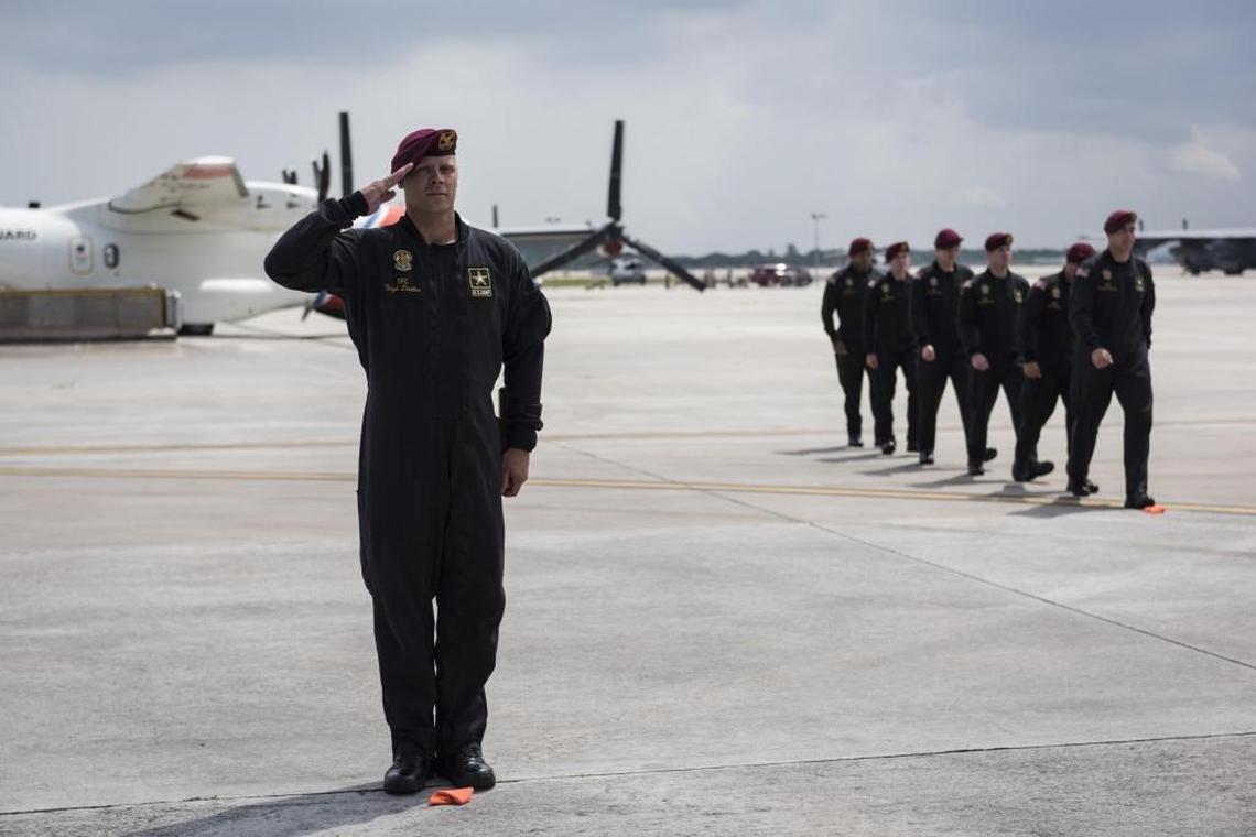 Golden Knight Teigh Statler stands in attention as he is presented at the Air and Sea Show Media Event at the Coast Guard Air Station Miami at Opa-locka Executive Airport on Friday, May 26, 2017.