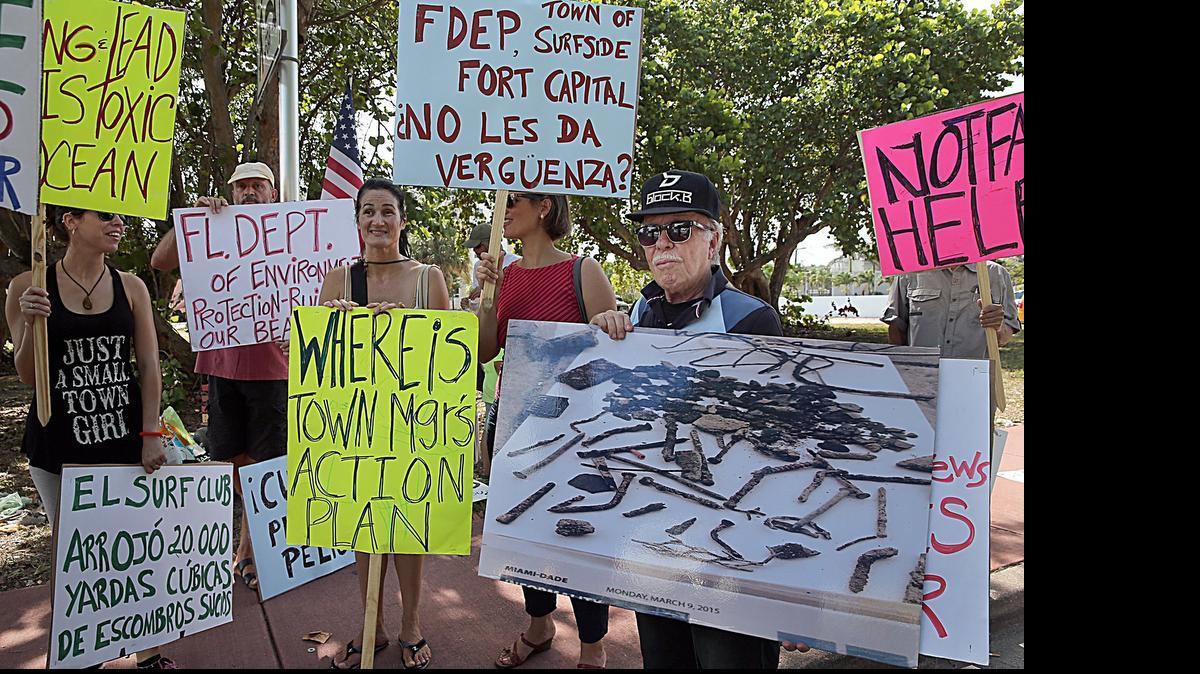 
Deborah Cimadevilla, left, Larisa Alonso, center, and Jose Toyos were among a group of Surfside residents protesting Friday, July 3, 2015, in Surfside, Fla., against what they say is toxic construction materials being dumped on the beach. 
