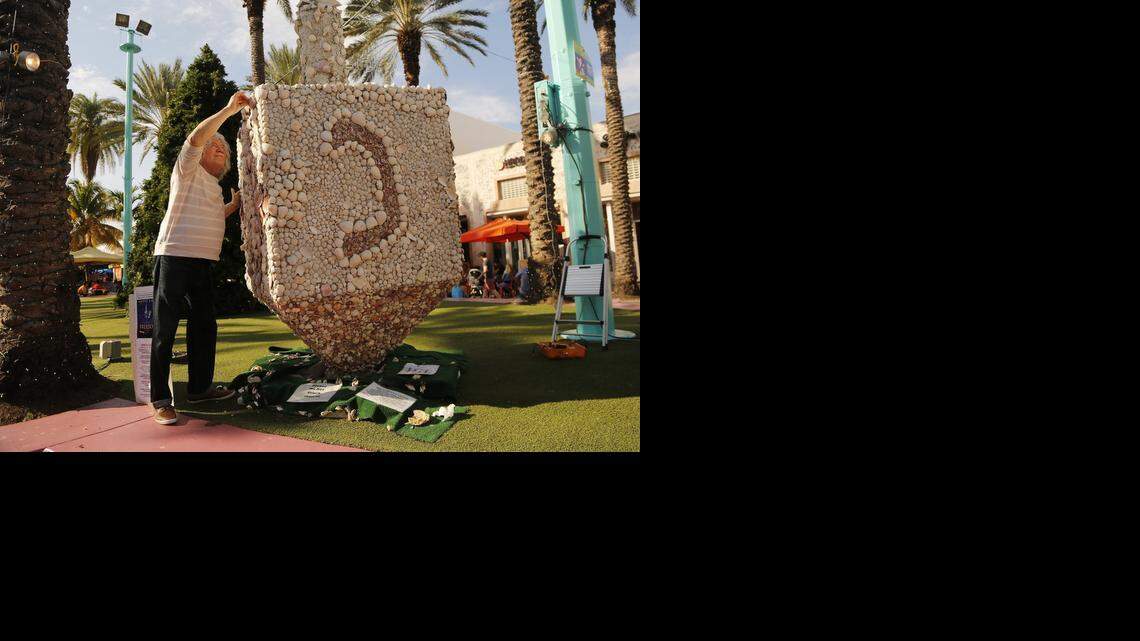 
For the past 13 years, Roger Abramson has been adding seashells to his dreidel and menorah now on display on Lincoln Road.

