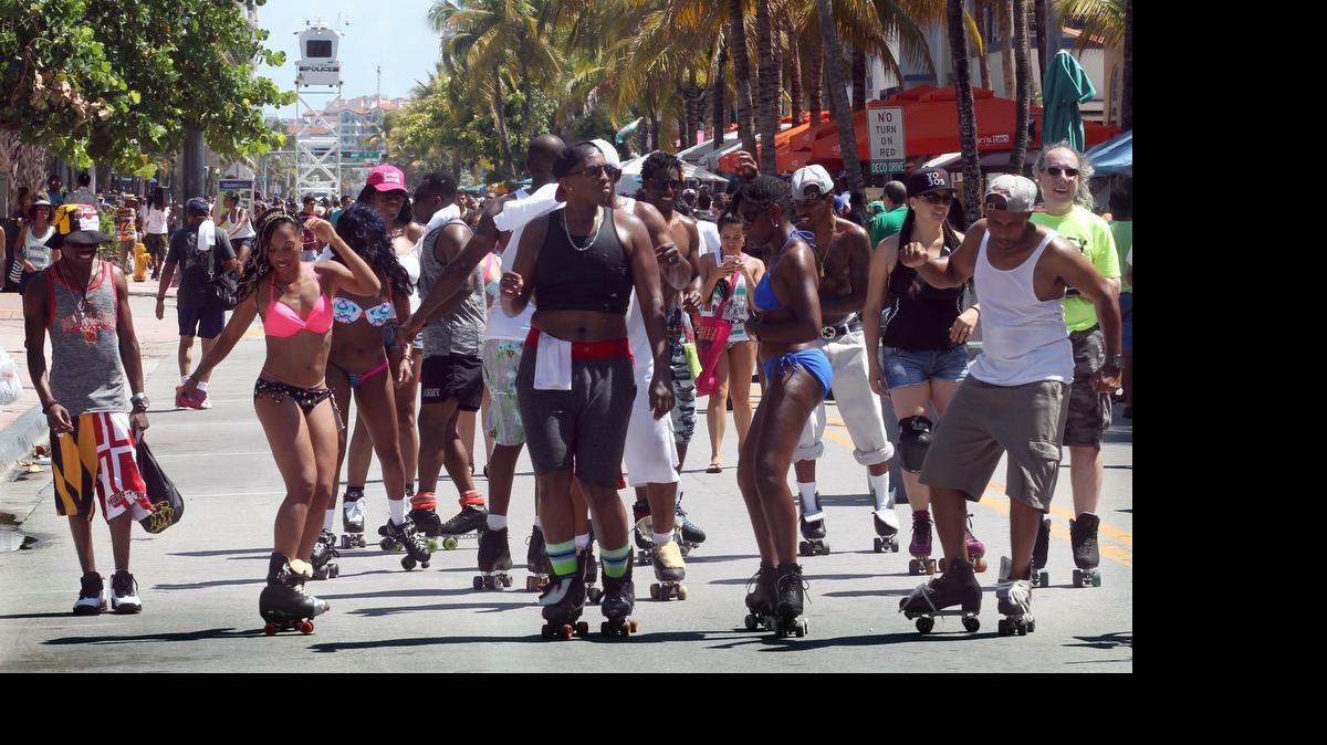 
Swimsuit-clad tourists and fashion-forward visitors dance outside bars as they make their way up and down Ocean Drive in Miami Beach on Saturday.
