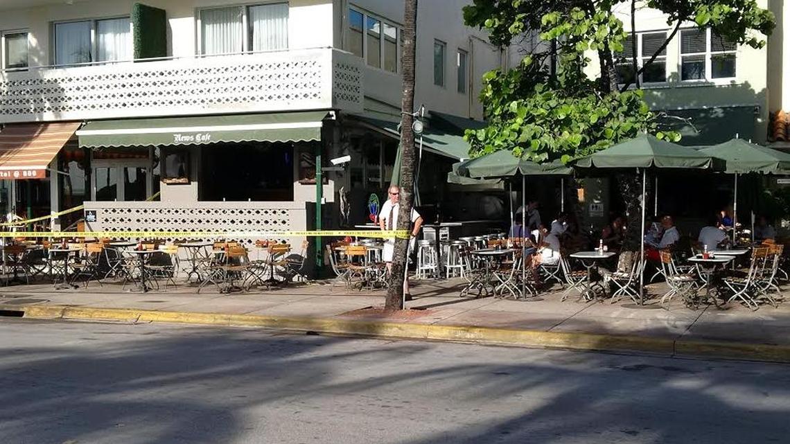 People continue to eat breakfast Sunday morning next to a shooting investigation at he News Cafe on Ocean Drive.