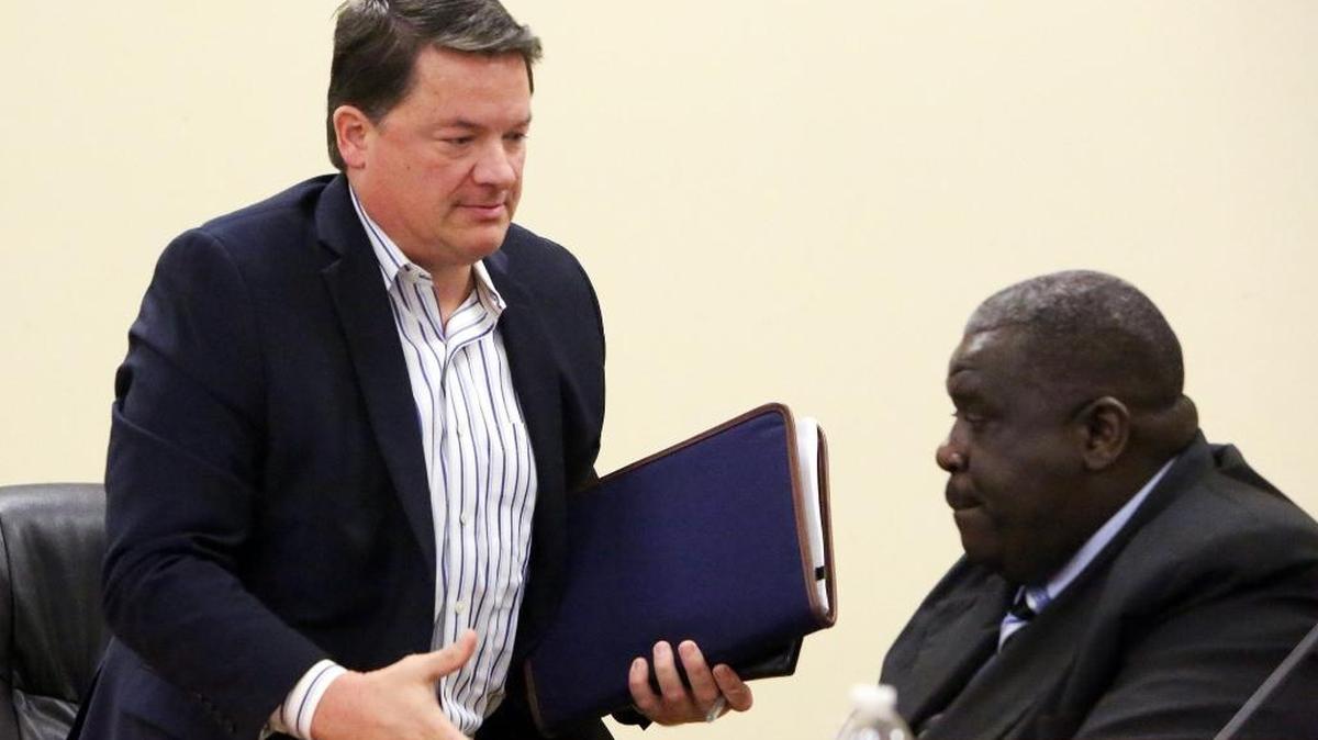 In November: Just-fired Opa-locka City Manager Steve Shiver rises from his seat and approaches then-assistant City Manager David Chiverton to shake his hand.