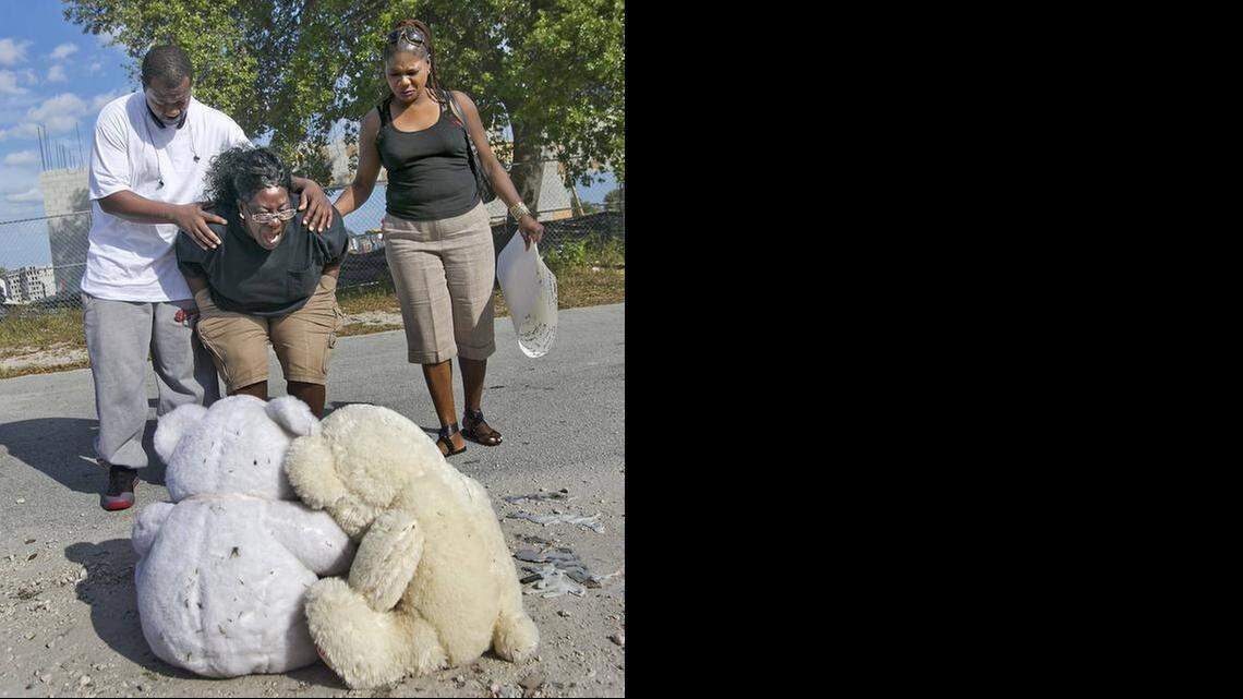 
Catherine Daniels is comforted by her nephew Tyrone Nelson and her cousin Elaine Ingraham Feb. 17, 2015, at a memorial for her son Lavall Hall, 25, who died Feb. 15 after being shot by Miami Gardens police. The family has filed suit against the city and former police chief.
