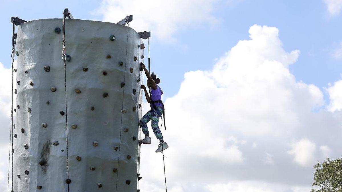 Anai Case, 10, of Miami Gardens, ascends a rock-climbing tower during the Zoe's Dolls' Girl Fit Experience on Saturday, July 23, 2016 at Rolling Oaks Park in Miami Gardens. The city is hosting another family health festival at the park on Saturday August 5, 2017.