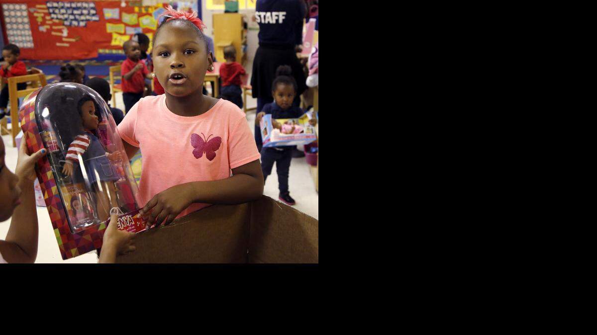 
Zoe Terry, 8, runs a nonprofit called Zoe's Dolls. She gave out donated dolls to young girls at the Love Thy Kids Academy #2 for the straight third year on Monday, Dec. 22, 2014.
