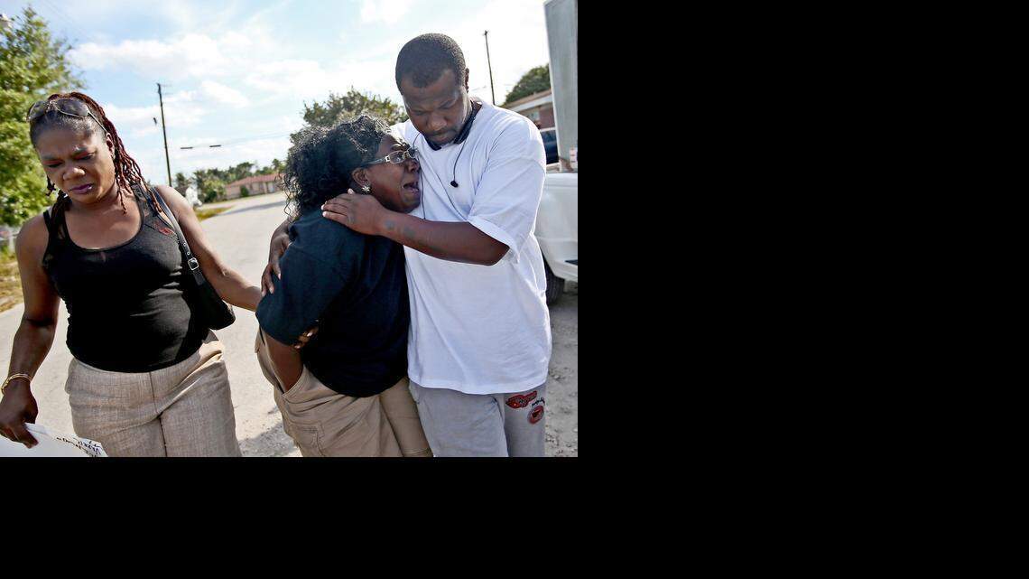 
Catherine Daniels is comforted by her nephew Tyrone Nelson and her cousin Elaine Ingraham at a memorial for her son Lavall Hall in Miami Gardens on Tuesday, Feb. 17, 2015.

