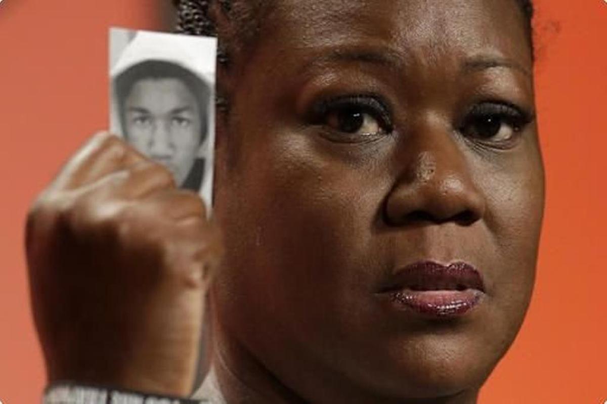 Sybrina Fulton, mother of Trayvon Martin, holds up a card with a photo of her son as she speaks at the National Urban League’s annual conference in Philadelphia in 2013, a year after her son, 17, was shot and killed by George Zimmerman in Sanford, Florida.