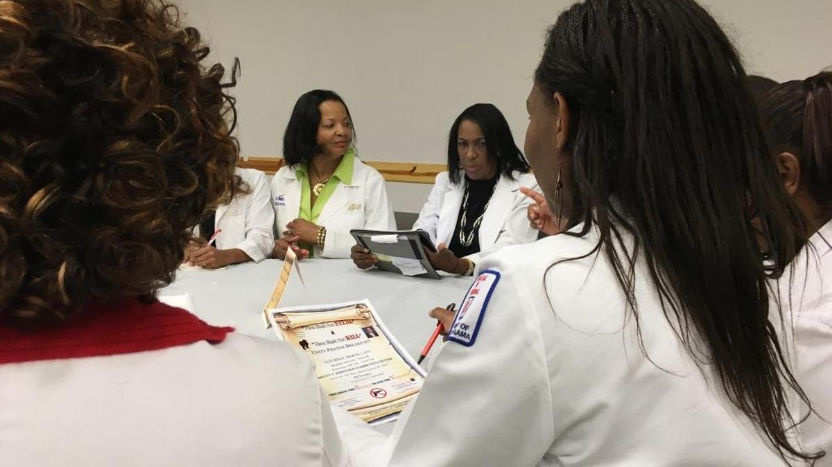 Black Nurses Association Vice President Deborah Robinson, left, and President Linda Brown, right, meet with members of the Miami chapter to address gun violence in Miami.