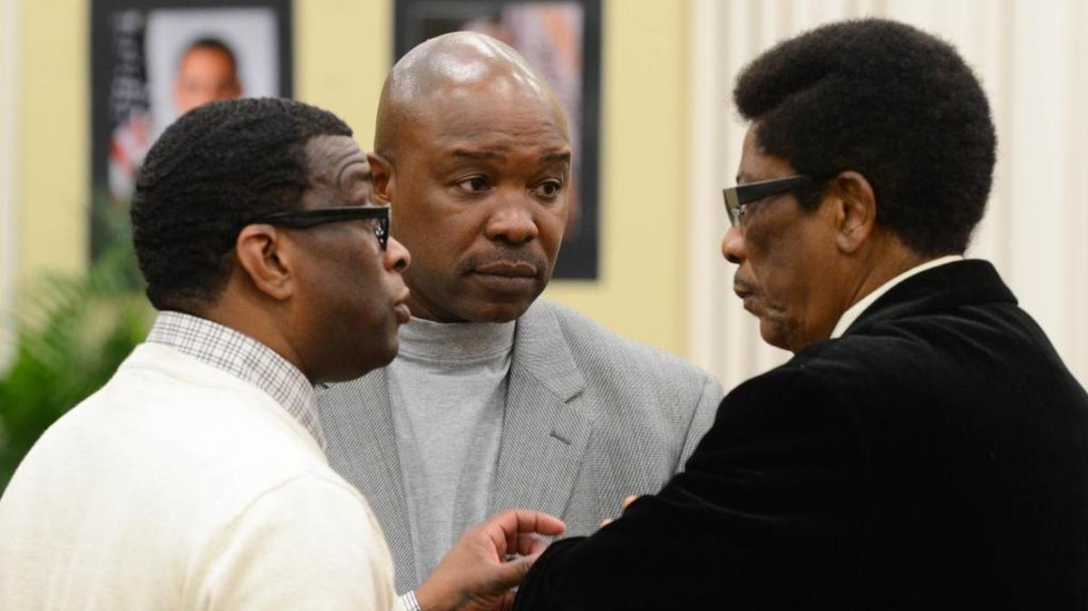 Dante Starks, left, Keith Carswell, center, and Bishop John Taylor, husband of Mayor Myra Taylor, speak after the Opa-locka state of the city address on Friday, Jan. 29, in Opa-locka.