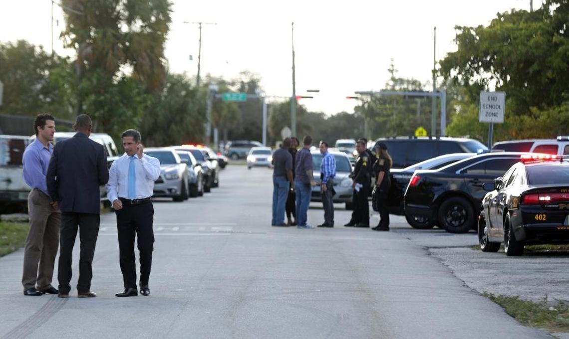 Miami-Dade Schools Superintendent Alberto Carvalho speaks with school officials at the scene where three students were shot near Carol City High School on Feb. 10, 2017.