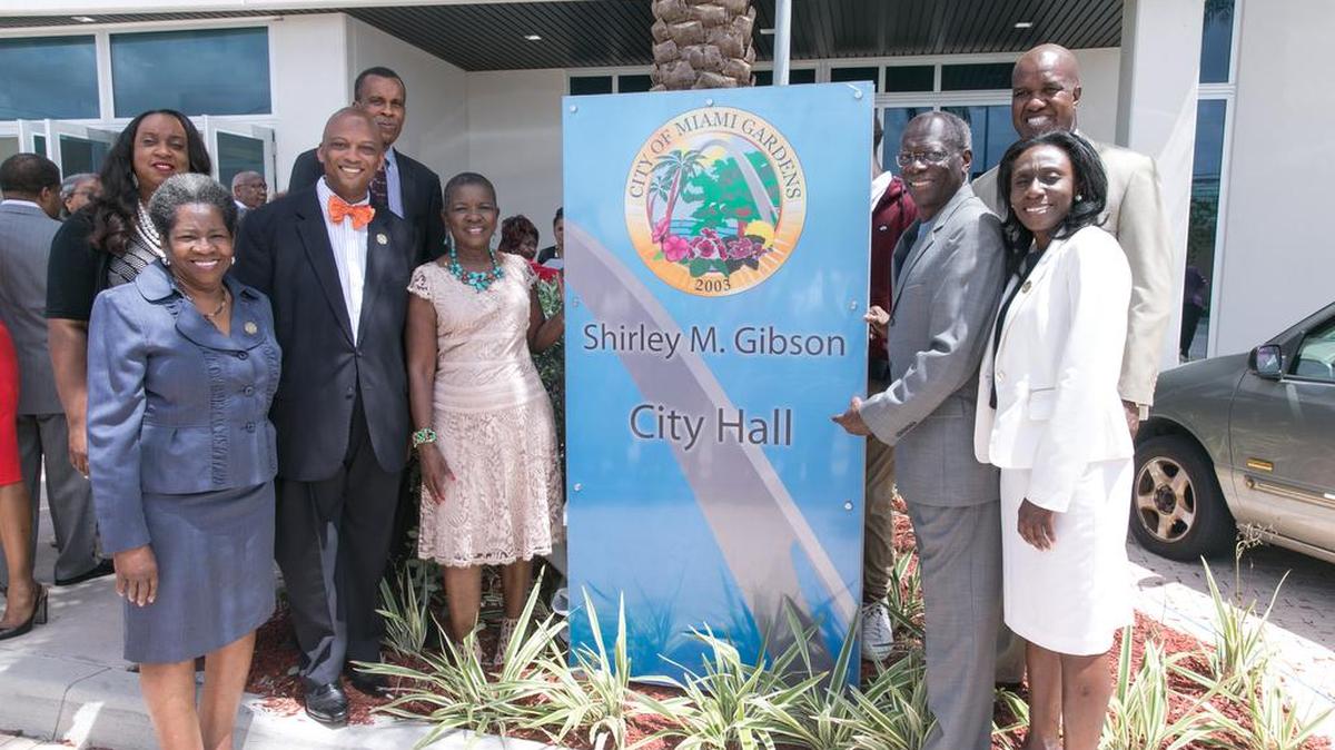 Former Miami Gardens Vice Mayor Aaron Campbell and Shirley Gibson, the city’s first mayor, pose with council members outside City Hall on July 20. The City Hall portion of the municipal complex is now named after Gibson.