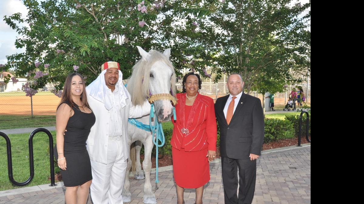 
City Clerk Joanna Flores, Commissioner Terence Pinder, Arabian Stallion, Mayor Myra Taylor and commissioner Luis B. Santiago in front of Sherbondy Village for the 89th Birthday celebration.

