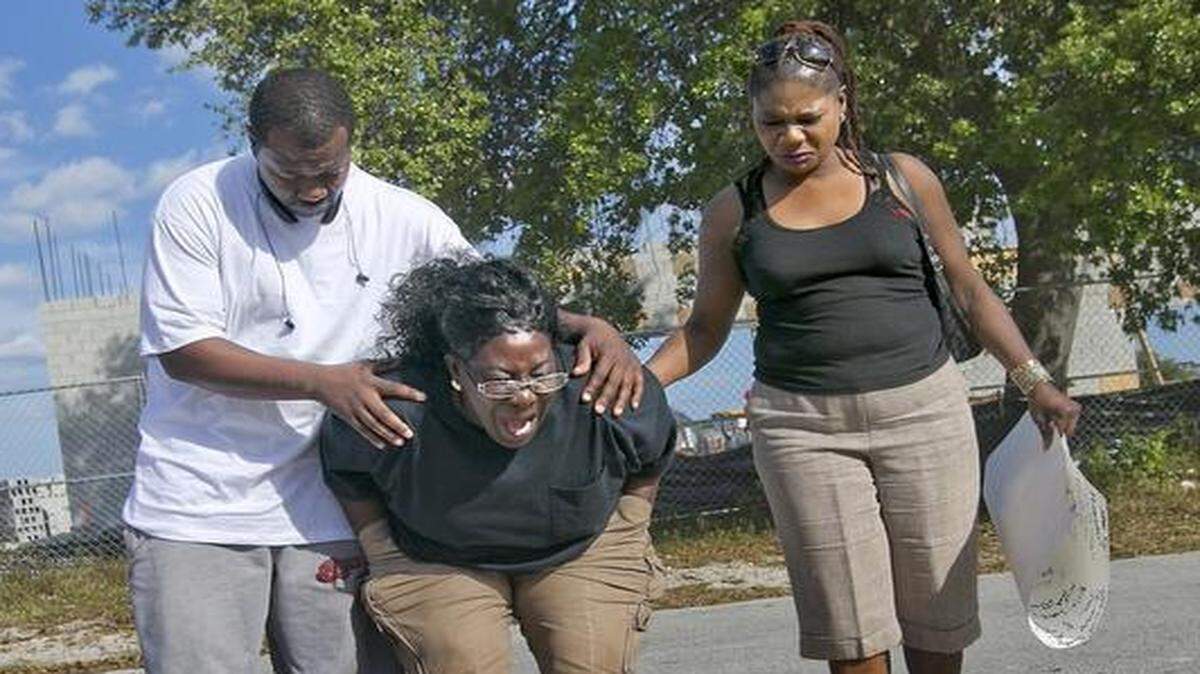 
Catherine Daniels is comforted by her nephew Tyrone Nelson and her cousin Elaine Ingraham Feb. 17, 2015, at a memorial for her son Lavall Hall, 25, who died Sunday morning after being shot by Miami Gardens police. Hall was brandishing a broomstick at police and was not following police commands, Miami Gardens Police Chief Stephen Johnson said.
