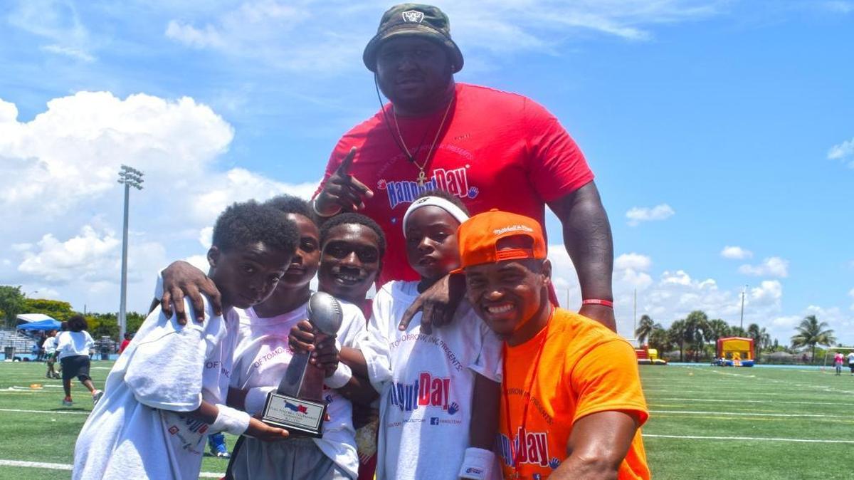 Max Jean-Gilles stands behind younger participants of the camp and volunteer Jemmy Jasmin on July 15 at Betty T. Ferguson Recreational Center in Miami Gardens.