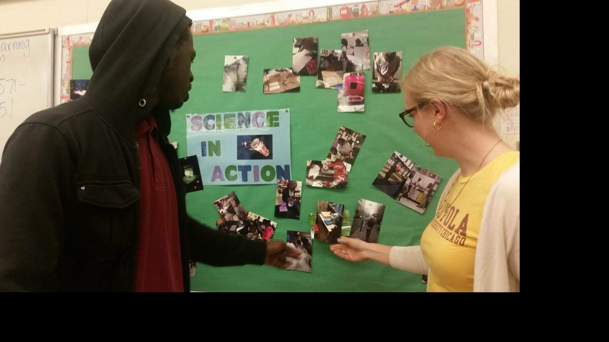 
William Delancy Jr. (left) looks at pictures from the Norland College Readiness Club’s college visit trip to Boston with his teacher Eva Robinson. The club is seeking additional funding for a Chicago college tour in May.
