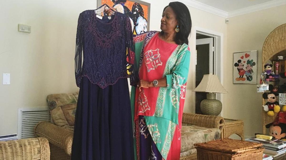 Former Opa-locka Commissioner Rose Tydus holds the dress she wore during the 2016 Ms. Senior Florida Pageant. Tydus, 69, was the first runner up and is planning to compete again next year.