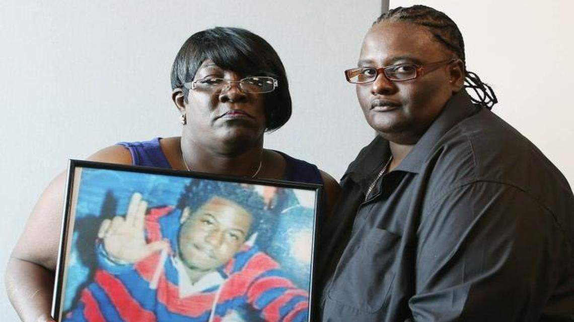 
Catherine Daniels Brown, left, and Marsha Brown, mothers of Lavall Hall, a mentally ill man shot dead by police in Miami Gardens, pose with a photo of Hall.
