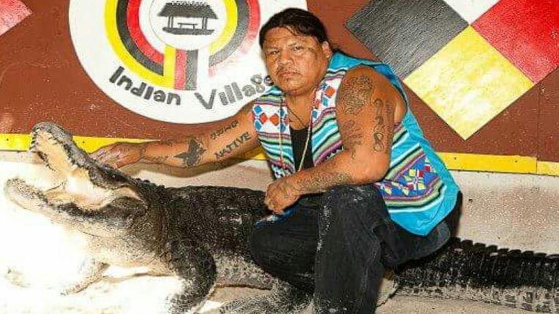 Rocky Jim Jr. holds an alligator at the Miccosukee Indian Village in Miami.