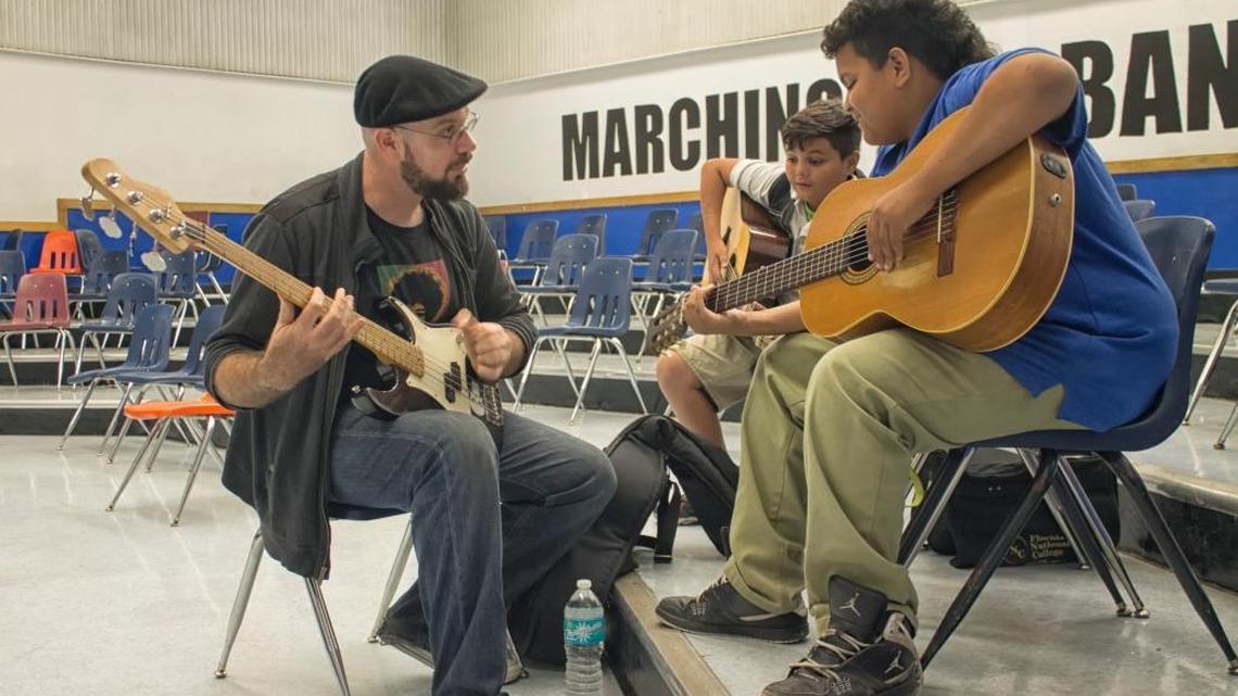 Danny Hayoun, guitar mentor, shows students the different styles of guitars and basic notes.