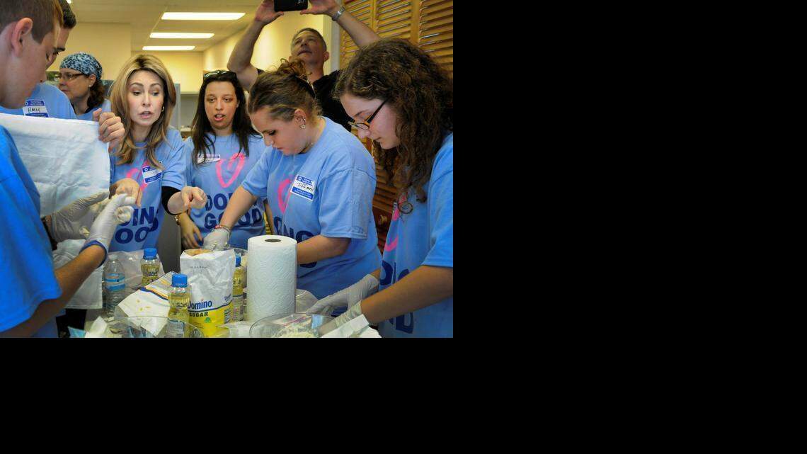 
Tobi Ash, a volunteer for the Greater Miami Jewish Federation Center, explains to the teens how to prepare the challah. High school students were paired with teens and young adults with special needs as part of a worldwide event dubbed Good Deeds Day on Sunday, March 15, 2015, to bake the braided bread.
