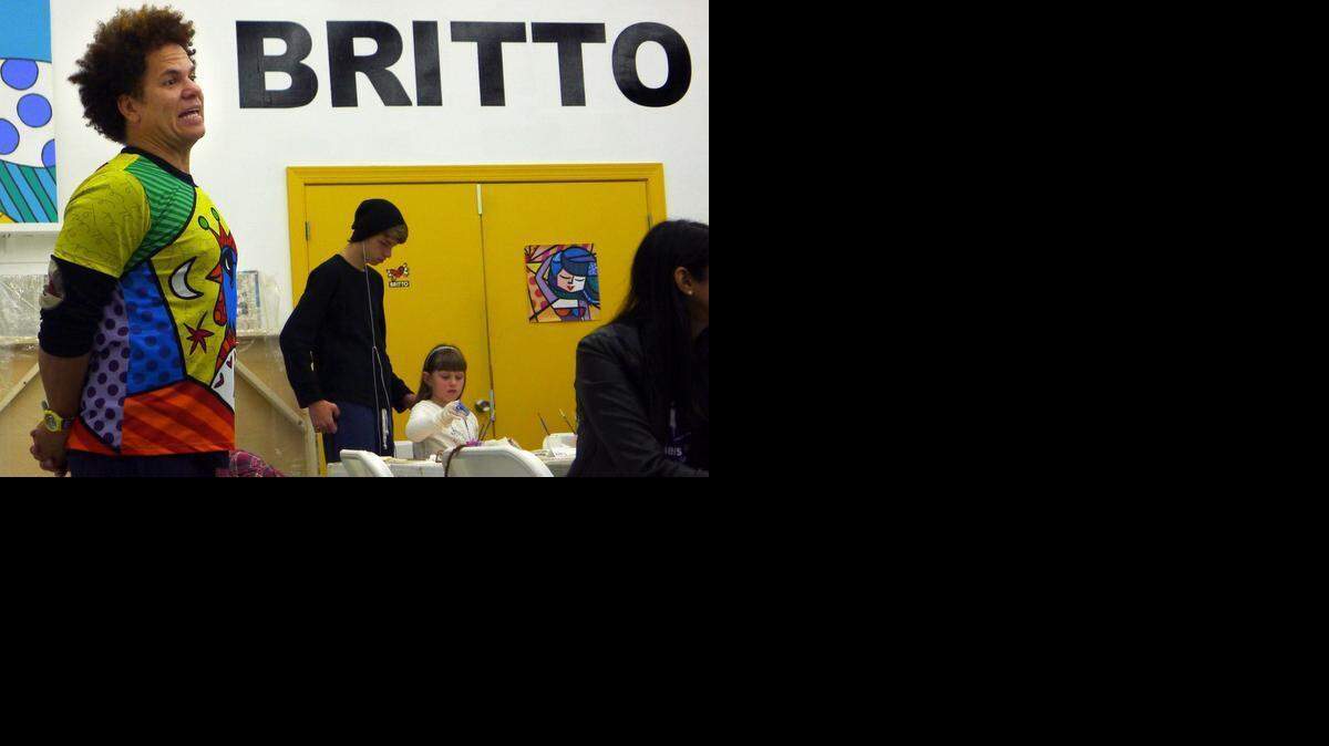 Romero Britto talks to members of Big Brothers Big Sister of Greater Miami about their art collaboration at his studio.