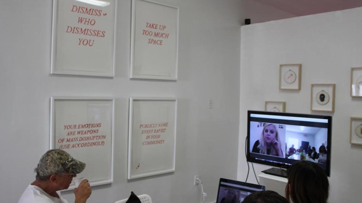 An attendee speaks with artist Maggie Dunlap at the &gallery virtual brunch for her exhibit ‘Tender’ in Little Haiti.