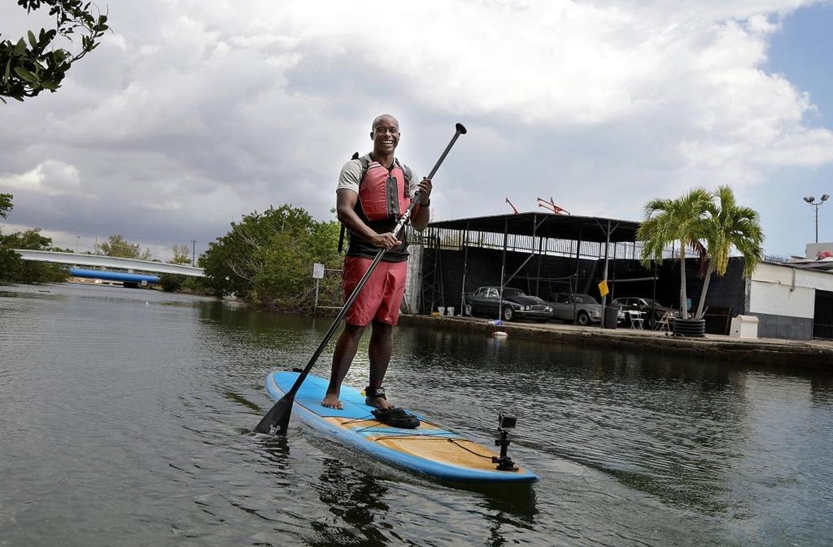 Parker Lake commutes to work on his paddleboard along Little River from his home in El Portal to one of his jobs at iPaddleMiami in Pelican Harbor Marina.