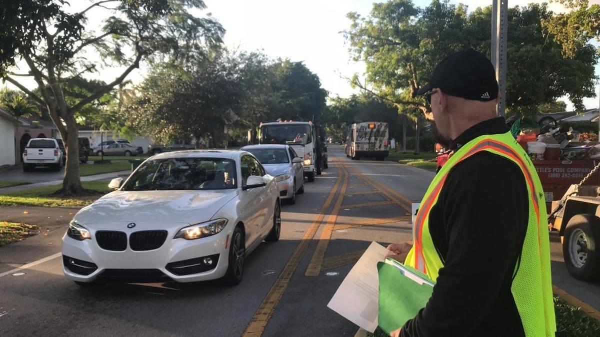 Palmetto Bay resident Bill Kestel stands alongside Southwest 87th Avenue near Southwest 164th Street on Tuesday during morning rush hour.