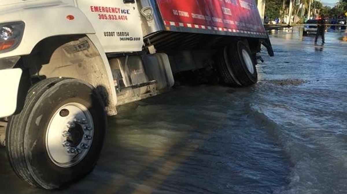 Thousands of gallons of water gushed from a broken water main Thursday afternoon in the Little River neighborhood of Miami, opening a sinkhole that almost swallowed an ice truck.