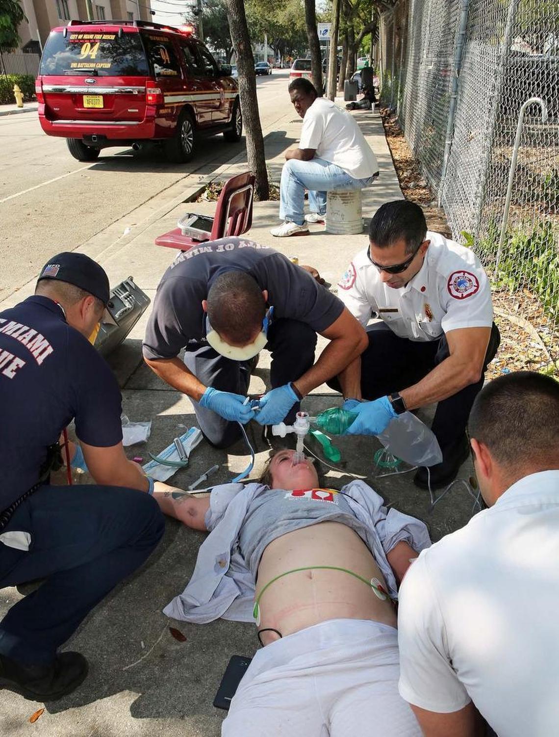 Captain Tony Milan-EMS Battalion Commander for City of Miami Fire Rescue, upper right, works on an overdose victim with his crew late last year, another in a heroin/fentanyl overdose crisis centered around Overtown.
