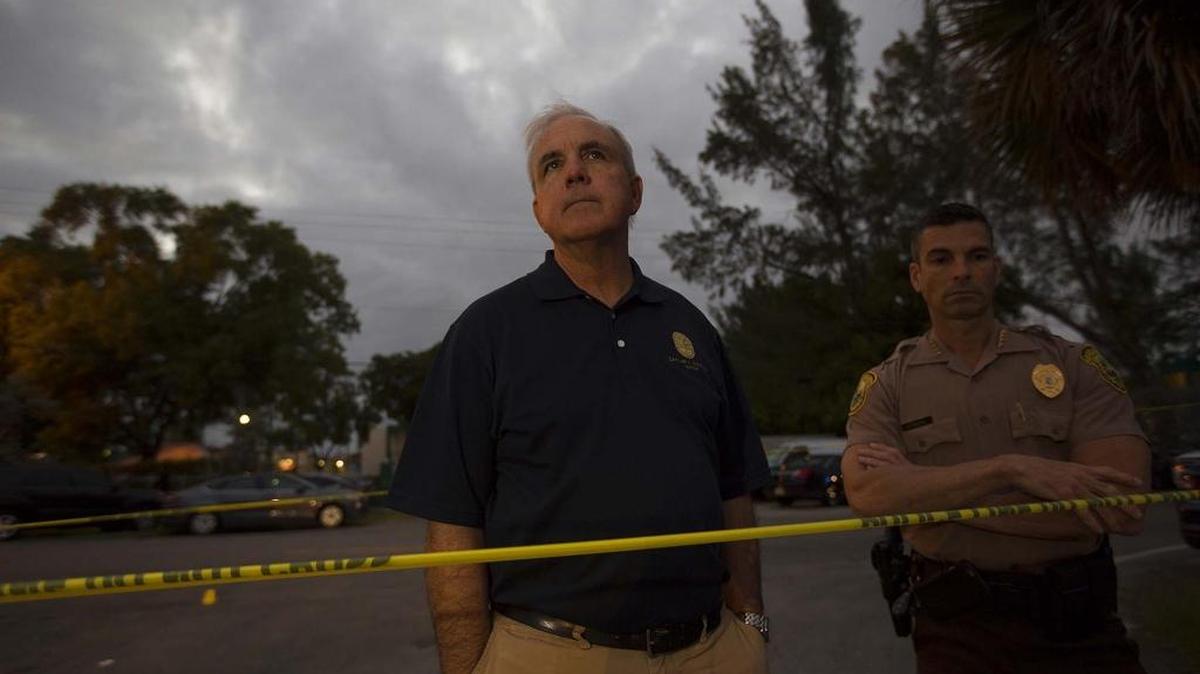 Miami-Dade Mayor Carlos Gimenez, left, and county police chief Juan Perez, outside apartment complex where 6-year-old King Carter was killed, in North West Miami on Saturday, Feb. 20, 2016.