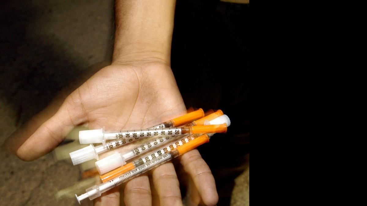 
Street addict shows his stash of needles in the overtown section of Miami.
