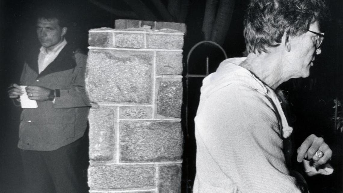 In this photo from 1987, Sen. Gary Hart, right, walks away from Miami Herald reporter Jim McGee after talking with Herald reporters about the identity of a woman staying in his townhouse on Capitol Hill in Washington.