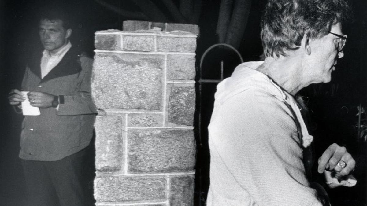 In this photo from 1987, Sen. Gary Hart, right, walks away from Miami Herald reporter Jim McGee after talking with Herald reporters about the identity of a woman staying in his townhouse on Capitol Hill in Washington.